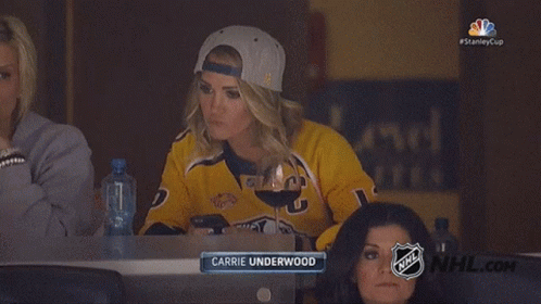 Carrie Underwood Is Sitting In The Stands Watching The Nhl Game GIF