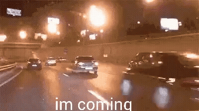 Cars Driving Down Highway At Night GIF