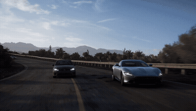 Cars Driving Down Road With Mountains GIF