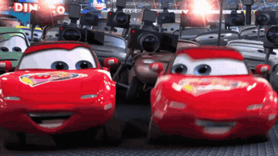 Cars Driving Past Dinoco Sign GIF