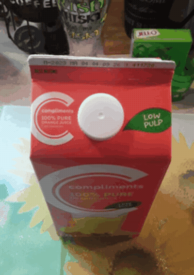 Carton Of Compliments Pure Orange Juice With White Lid GIF
