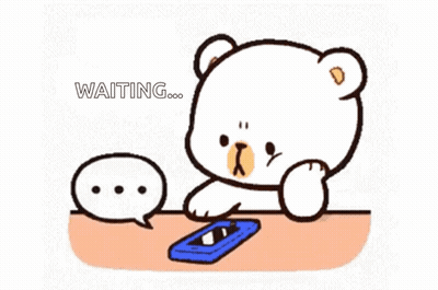 Cartoon Bear Sitting At Table With Cell Phone GIF