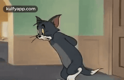 Cartoon Cat In Hallway With Mouse In Mouth GIF