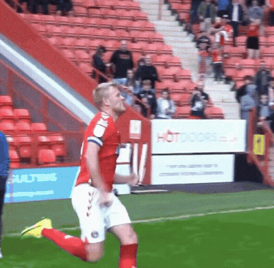 Cartoon Cat In Red Shirt Jumping On Soccer Field GIF