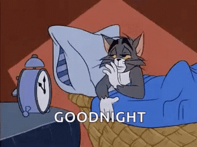 Cartoon Cat Laying In Bed With Alarm Clock GIF