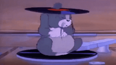 Cartoon Cat Sitting On Record Player With Record On Head GIF