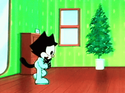 Cartoon Cat Standing By Christmas Tree GIF