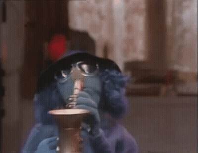 Cartoon Character Drinking From Cup With Glasses and Hat