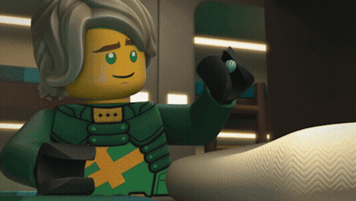 Cartoon Character In Green And Yellow Outfit With Yellow X On Chest GIF