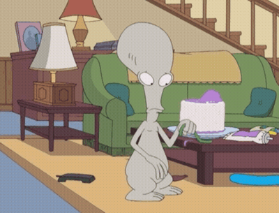 Cartoon Character In Living Room With Cake GIF