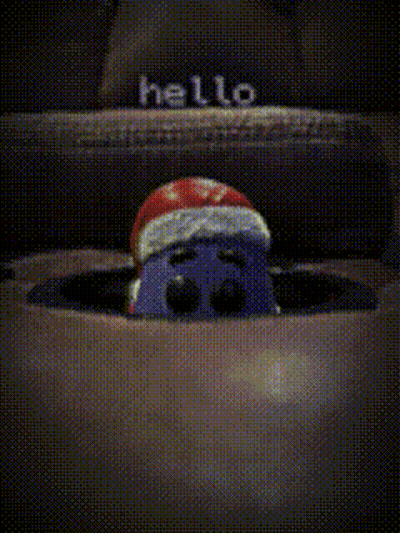Cartoon Character In Santa Hat Peeking From Box GIF