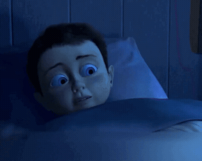 Cartoon Character Laying In Bed With Blue Blanket GIF