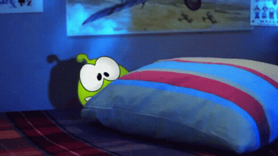 Cartoon Character Laying On Bed With Striped Pillow GIF