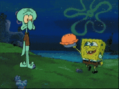 Cartoon Character Laying On Ground With Rock GIF