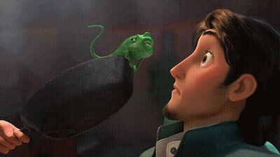 Cartoon Character Looking At Green Lizard On Pan GIF