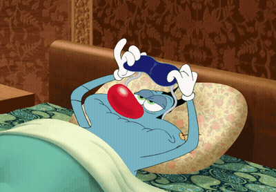 Cartoon Character Lying In Bed Holding Blue Object GIF