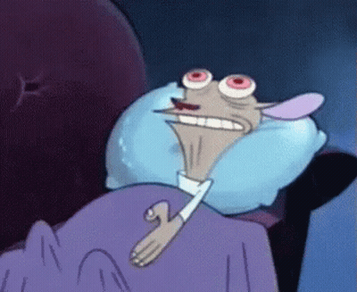 Cartoon Character Lying In Bed With Blue Pillow GIF