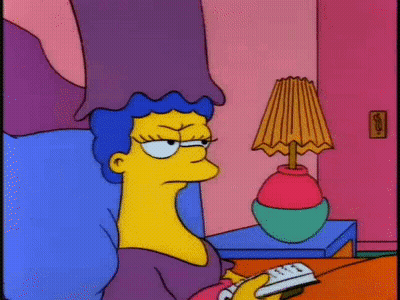 Cartoon Character On Bed With Remote And Lamp GIF