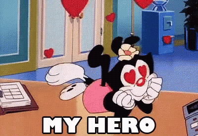 Cartoon Character Saying My Hero Sitting On Table GIF