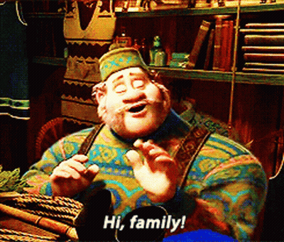 Cartoon Character Says Hi Family In Front Of Bookshelf GIF