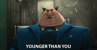 Cartoon Character Says Younger Than You In Front Of Vault GIF