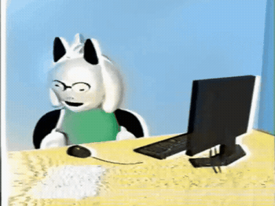 Cartoon Character Sitting At Desk With Computer And Mouse GIF