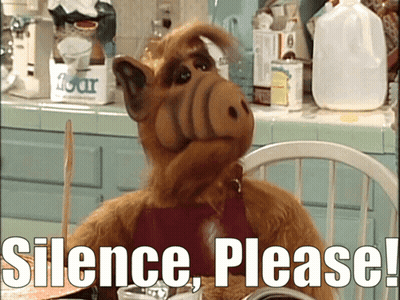 Cartoon Character Sitting At Table Saying Silence Please GIF