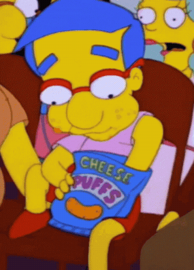 Cartoon Character Sitting In Chair Holding Cheese Puffs GIF
