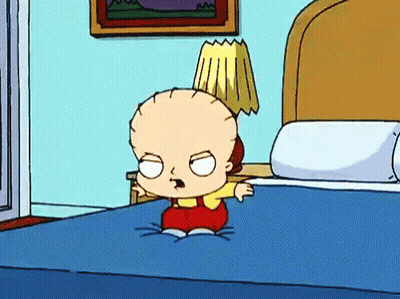 Cartoon Character Sitting On Bed With Lamp On Head GIF