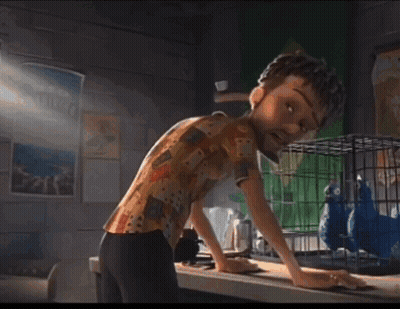 Personaje de caricatura parado frente a jaula con dos pájaros azules GIF