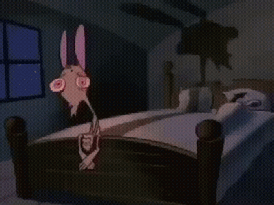 Cartoon Character Standing On Bed In Dark Room GIF