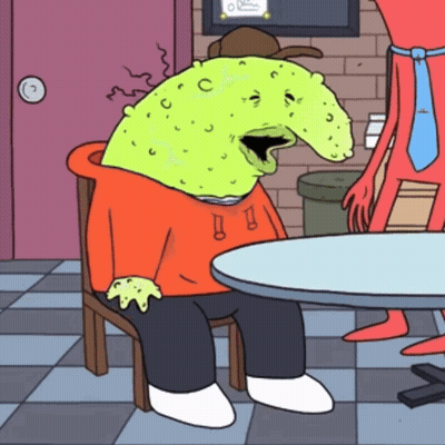 Cartoon Character With Green Head Sitting At Table GIF