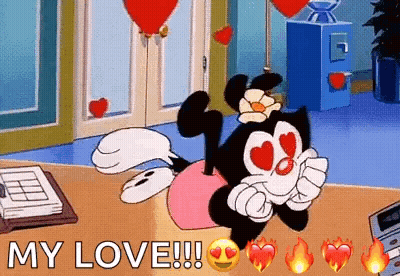 Cartoon Character With Heart Eyes Lying On Desk GIF