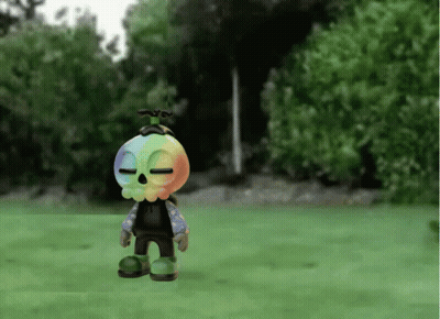 Cartoon Character With Rainbow Head Standing On Grass GIF