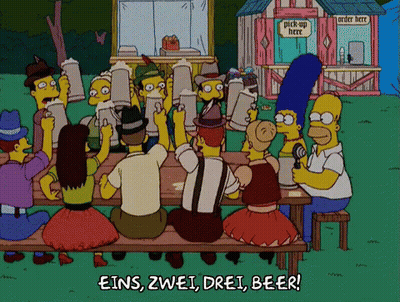 Cartoon Characters Sitting At Picnic Table With Pick Up Here Sign GIF
