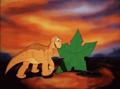 Cartoon Dinosaur Standing Next To Leaf GIF