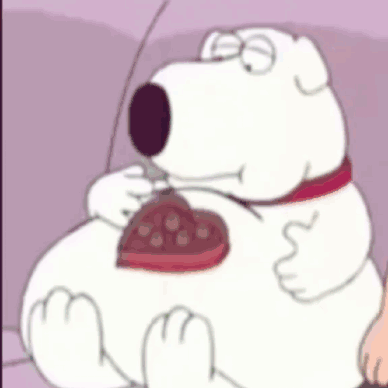 Cartoon Dog Sitting On Couch Eating Chocolate Heart GIF