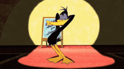 Cartoon Duck Dancing In Front Of Educate For A Lifetime Sign GIF