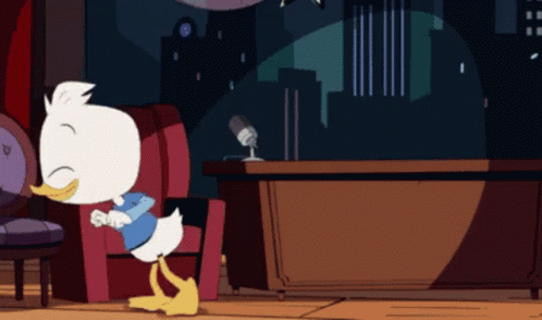 Cartoon Duck Sitting in Chair With Microphone