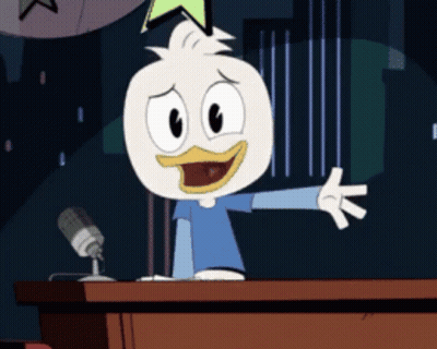 Cartoon Duck Standing At Podium With Microphone GIF