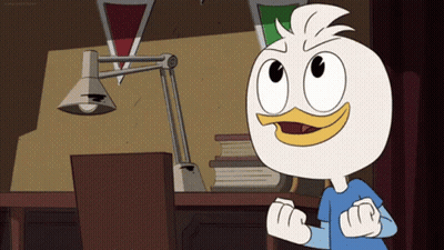 Cartoon Duck Standing In Front Of Desk With Lamp GIF