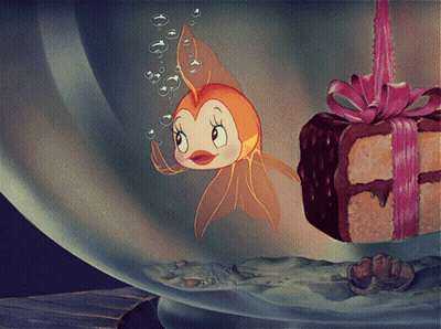 Cartoon Fish Swimming Beside Cake With Bow GIF
