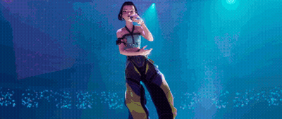 Cartoon Girl Singing Into Microphone On Stage GIF