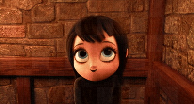 Cartoon Girl With Big Blue Eyes Standing Before Stone Wall GIF