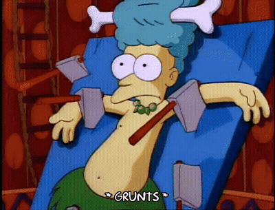 Cartoon Laying On Bed With Bone On Head Grunts GIF