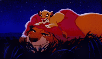 Cartoon Lion Laying Down With Cub On Head GIF