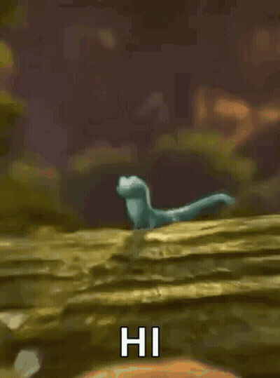 Cartoon Lizard Standing On Rock Waving GIF