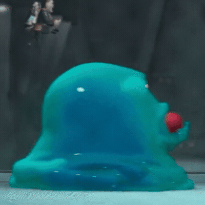 Cartoon Looking At Blue Blob With Red Eyes GIF