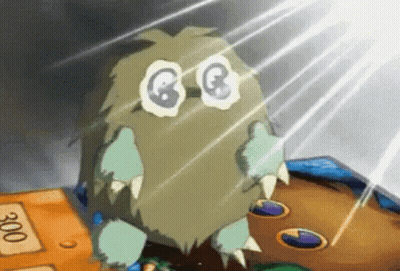 Cartoon Monster With Big Eyes And Sharp Teeth On Table GIF