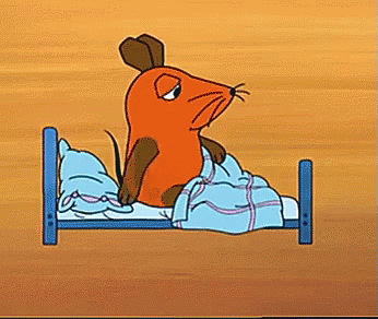 Cartoon Mouse Sitting On Bed With Blue Blanket GIF